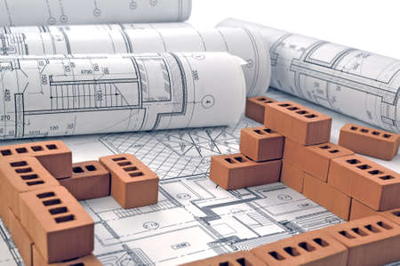 Photo brown bricks lying on the project drawingsの写真素材