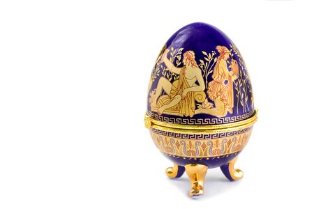 Casket of blue color with a gold list  It is executed in the form of an Easter egg, it is painted with scenes from antique lifeの写真素材