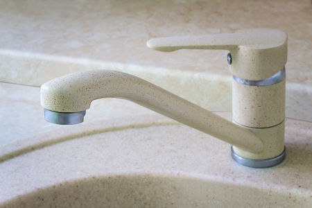 The crane for water is installed on a sink for ware.の写真素材