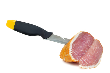 Tasty piece of ham on a knife edge . Presented on a white background.の写真素材