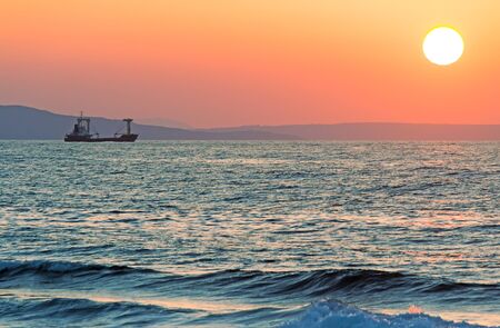 Sunset at sea off the coast of the Mediterranean sea.の写真素材