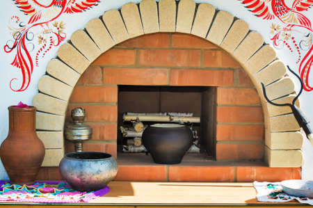 Made of brick layout old stove with firewood inside. Nearby is the old dishes. The layout is beautifully decorated.の写真素材