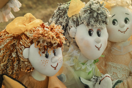 Souvenirs in the form of amusing dolls sewed from scraps of fabric , thread, lace. Handmade.の写真素材
