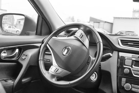 A fragment of the interior of the car opposite the driver's seat: steering wheel, speedometer,...