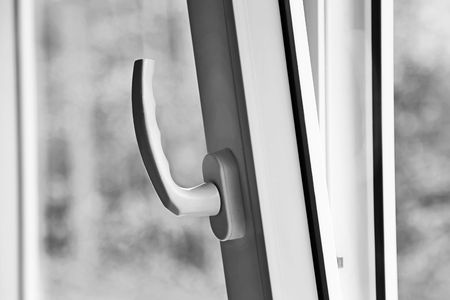 A fragment of an open casement window with lock and handle.の写真素材