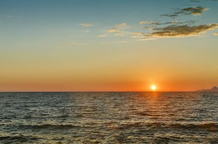 Sunset at sea off the coast of the Mediterranean sea.の写真素材