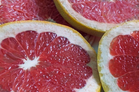 On the table cut fruit grapefruit. Presents closeup. The view from the top.の写真素材