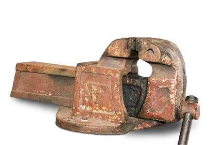 Large vintage cast iron vise for a variety of types of technical work. Presented on a white...