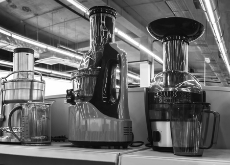 In the store, the exhibition presents modern juicers various models. Black-and-white image.の写真素材