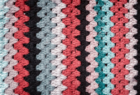 A fragment of hand-made panels made of multicolored threads.