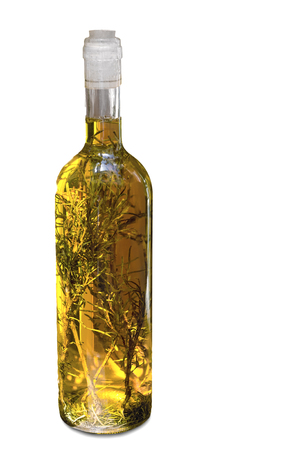 Bottle of olive oil along with herbs on white background.の写真素材
