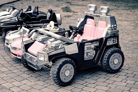 Attraction in the Park for children: small cars on which you can drive and control the children.