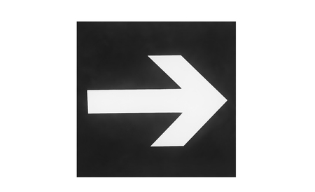 A sign on the wall with a direction indicator in the form of an arrow. Presented on a white background. Black and white image.の写真素材