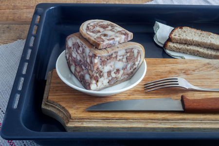 On the table on a tray sliced pork stomach stuffed with meat and bacon.の写真素材