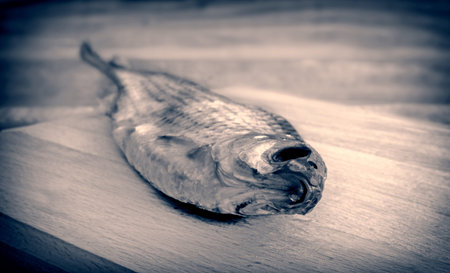On the table on the cutting Board dried roach. Presented close-up.