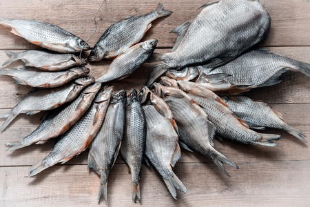A large bunch of dried roach on the wire lies on the surface of the table.の写真素材