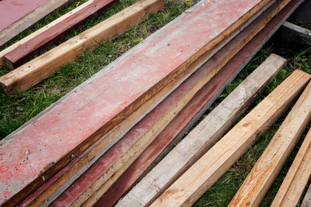 Old boards, sticks, slats piled up in a heap after repair of the premises. Intended for disposal or...