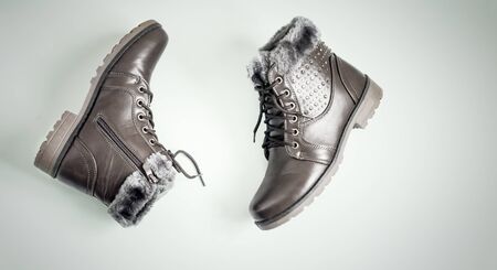 Comfortable and warm winter boots with gray fur inside, zipper and lacing. Presented on a light background. Top view, copy spaceの写真素材