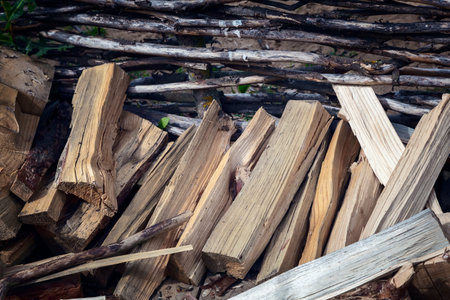 Near the wicker fence are chopped wood for the fireplace.