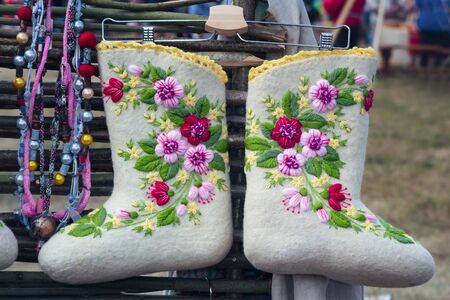 The fair sells warm and beautiful shoes made of felt in the national style, decorated with embroidery.の写真素材