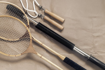 Sports and training equipment: badminton racket, jump rope, fitness stick. Top view, copy space.の写真素材