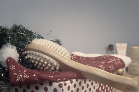 Massage brush and Christmas decorations on wooden background.の写真素材