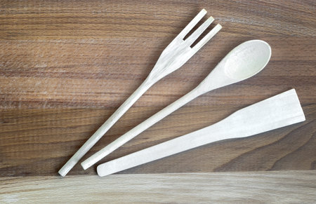Kitchen accessories: wooden spatula and wooden spoon.