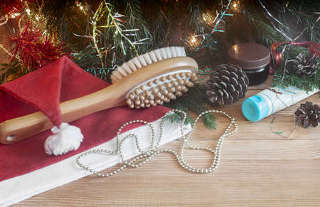 Massage brush and Christmas decorations on wooden background.の写真素材