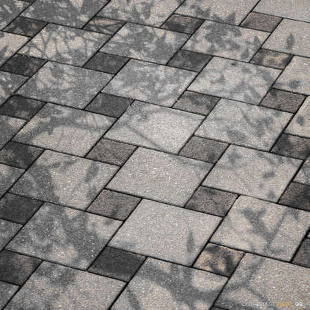 A fragment of the sidewalk covered with ceramic tilesの写真素材