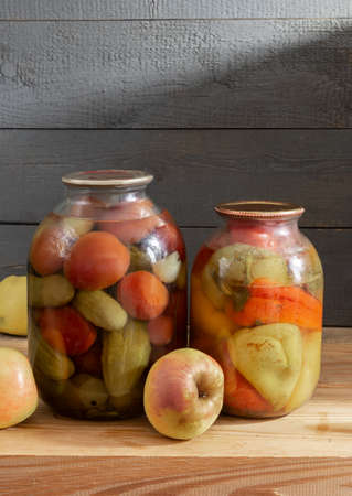 Canned vegetables in glass jars on a shelf in the basementの写真素材