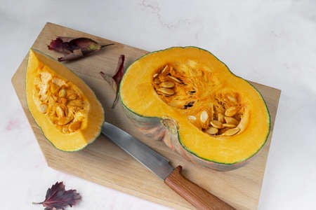 Sliced ripe pumpkin with seeds inside the fruitの写真素材