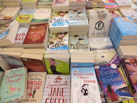 TANGERANG, INDONESIA - April 9, 2018: Stacks of fiction books for sale on books fair at ICE BSD City.のeditorial素材