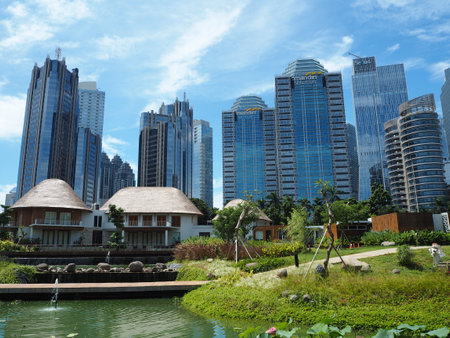 Jakarta, Indonesia - March 23, 2019 : City park of Gelora Bung Karno sports complex on Sudirman area with background of high rise buildings in Sudirman Central Business District.のeditorial素材