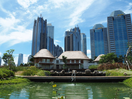 Jakarta, Indonesia - March 23, 2019 : City park of Gelora Bung Karno sports complex on Sudirman area with background of high rise buildings in Sudirman Central Business District.のeditorial素材