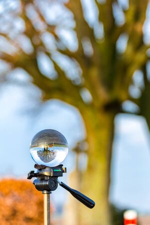 Glass ball pictures in nature with tree, windmill, sunset and field.の写真素材