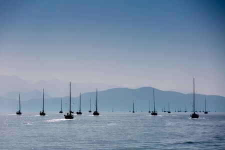 Gold romantic sunset with silhouette of yachtの写真素材
