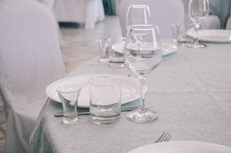 Empty white dinner plate on a table in a restaurant