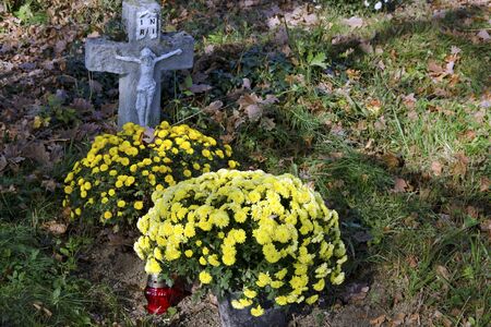 The old rustic grave on cemetery on All Saints Day.のeditorial素材