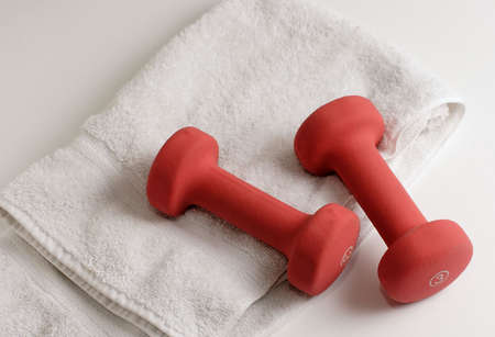 Pair of dumbells and white towelの写真素材