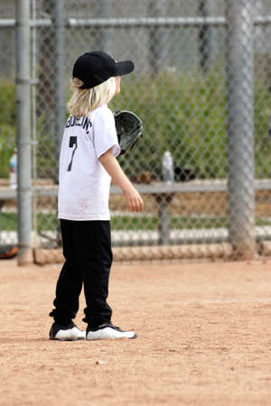 Little girl playing baseballの写真素材