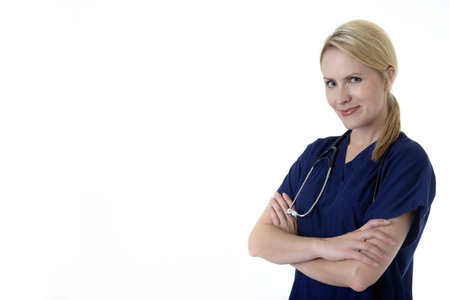 Pretty nurse with arms crossed standing on white backgroundの写真素材
