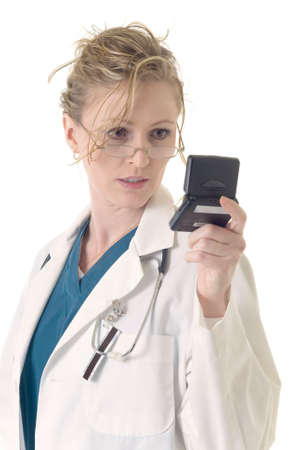 Attractive lady doctor reading messages from 2 way pagerの写真素材