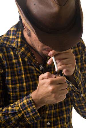 cowboy lighting a cigaretteの写真素材