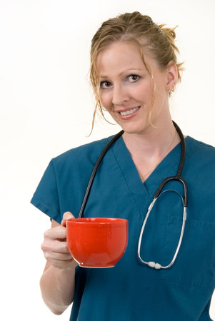 Attractive doctor holding a huge red coffee mugの写真素材