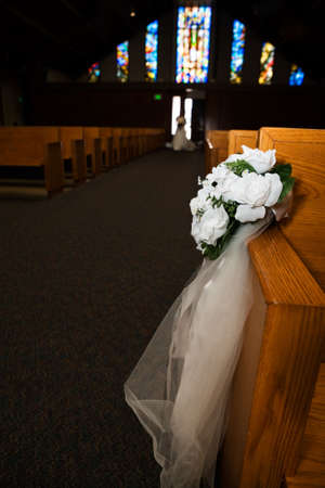 Flower arrangement in a church on side of pewのeditorial素材