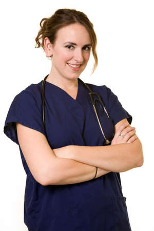 Young brunette woman doctor wearing dark blue scrubs uniform with arms crossed smiling standing on white backgroundの写真素材