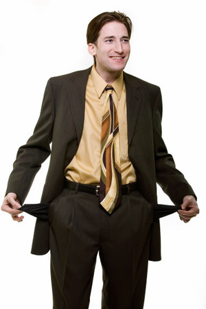 Young man wearing business suit holding on to empty pants pockets showing no money or brokeの写真素材
