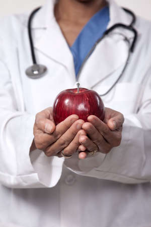 Doctor recommending healthy fruit dietの写真素材
