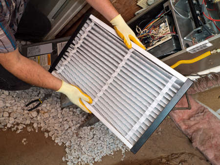 Hispanic airconditioning repair man performing maintenance