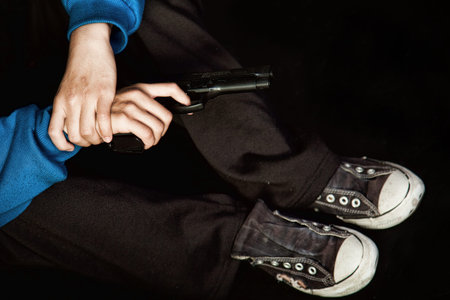 Teenage gangster holding gun